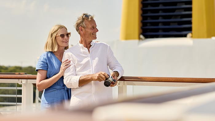 A couple enjoying the view from the Sun Deck on Spirit of Adventure